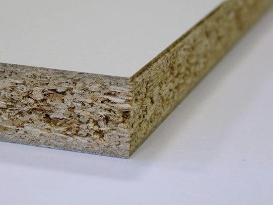 Close-up of a white-faced particle board edge